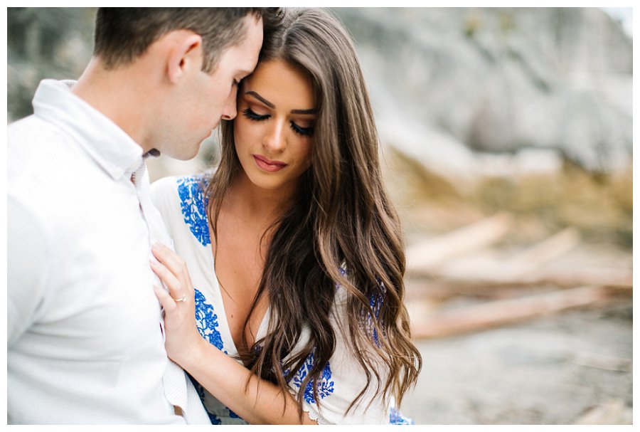 lighthouse engagement couple hugging